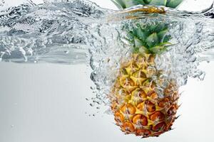 A pineapple is being splashed into the water photo