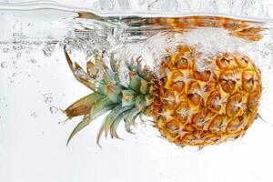 A pineapple is submerged in water photo