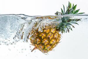 A pineapple is submerged in water photo