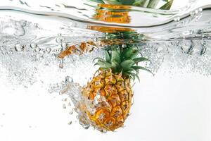 A pineapple is submerged in water photo