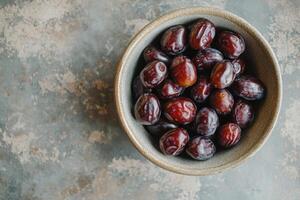 A bowl of dates on a table photo