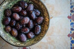 A bowl of dates on a table photo