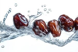 Dates falling into water on a white background photo