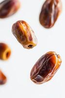 Dates are flying in the air on a white background photo