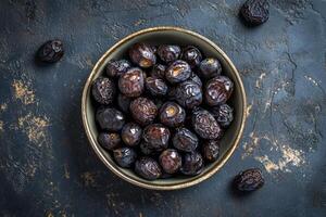 Dates in a bowl on a dark background photo