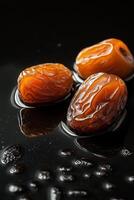 Three dates are sitting on a black surface photo