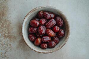 A bowl of dates on a table photo