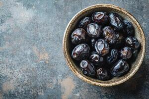 Dates in a bowl on a dark background photo