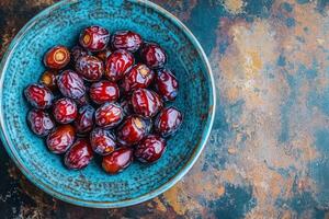 A bowl of dates on a table photo