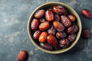 Dates in a bowl on a dark background photo
