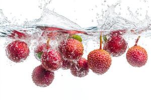 Fresh lychee fruit falling into water photo