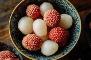 A bowl of lychees on a table photo