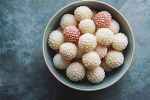 A bowl filled with white and pink balls photo