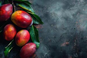 Mangos on a dark background with leaves photo