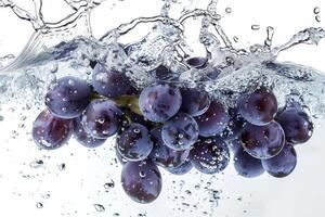 A bunch of grapes is being splashed into water photo