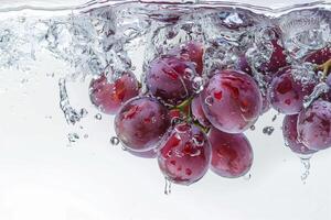 A bunch of grapes is submerged in water photo