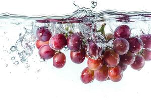 A bunch of grapes is being splashed into the water photo