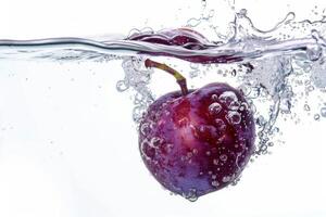 A purple apple is being splashed into the water photo