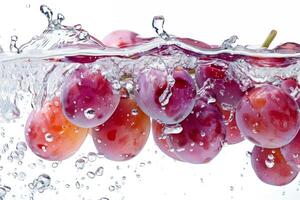 A bunch of grapes is being splashed into the water photo