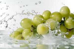 A bunch of grapes being splashed with water photo