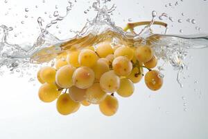 A bunch of grapes is being splashed into the water photo