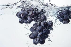 A bunch of grapes is being splashed into the water photo