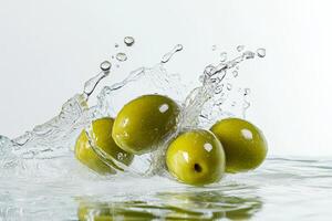 Olives falling into water with water splashes photo