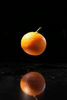 A single orange is floating in the air photo
