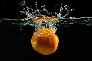 An orange is falling into water with a splash photo