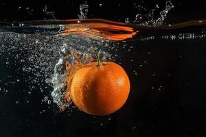 A single orange is floating in water photo