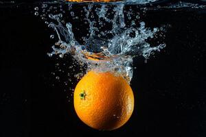 An orange being splashed with water photo