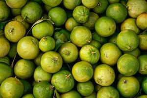 A large pile of green limes photo