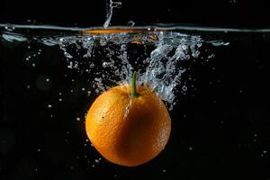 An orange is being splashed into the water photo