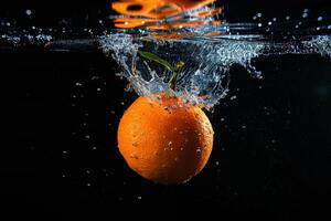 An orange being splashed in water photo