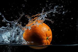 An orange is splashing in water photo