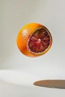A blood orange is floating in the air photo