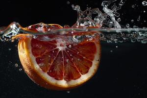 A grapefruit is being splashed in water photo