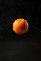 A single orange is floating in the air photo