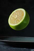 A slice of lime is floating in the air photo