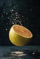 A slice of lemon is being sprayed with water photo