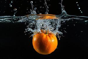 An orange being splashed in water photo