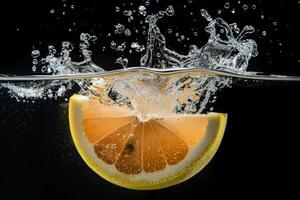 A slice of orange is being splashed into water photo