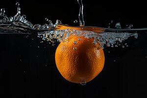 An orange being dropped into water photo