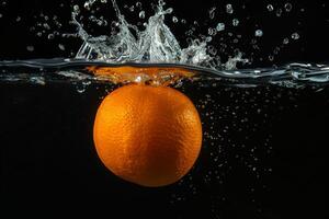 An orange is being splashed into the water photo