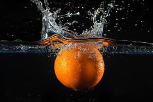 An orange being splashed with water photo