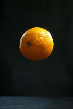 An orange floating in the air photo