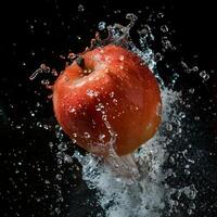 A red apple is being splashed with water photo