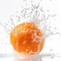 An orange is being splashed with water photo