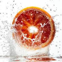 A grapefruit being splashed with water photo