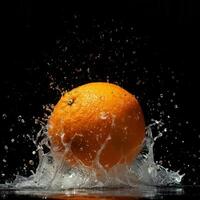An orange is splashing in water on a black background photo